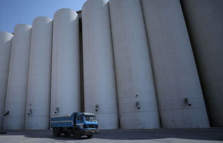 A truck drives past wheat storage in Qamishli, Syria September 18, 2017. REUTERS/Rodi Said