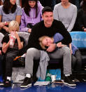 <p>The <em>Ray Donovan</em> star took his boys to see the New York Knicks play the Orlando Magic at Madison Square Garden Sunday night. While Alexander, 10, munched on popcorn, it seems Samuel, 8, got a little sleepy during the game — good thing he found the perfect place to lay his head for a quick time-out! (Photo: James Devaney/Getty Images) </p>