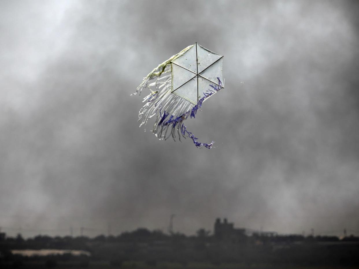 A kite flies over the border in an area where kites and balloons have caused blazes, between Israel and Gaza: Reuters