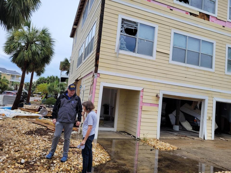 Escambia County Commissioner Robert Bender, who represents Pensacola Beach, talks with homeowner Betty Clay. Her home in DeLuna Point was damaged by the tornado.