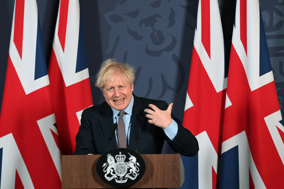 FILE - In this file photo dated Thursday, Dec. 24, 2020, Britain's Prime Minister Boris Johnson speaks during a media briefing at Downing Street in London, backdropped by British Union flags. Britain's relationship with the European Union will change from Jan. 1 when Britain embarks on a more distant relationship with the EU and freedom of movement becomes the most tangible consequence of Brexit for people and businesses. (Paul Grover/Pool Photo via AP, FILE)