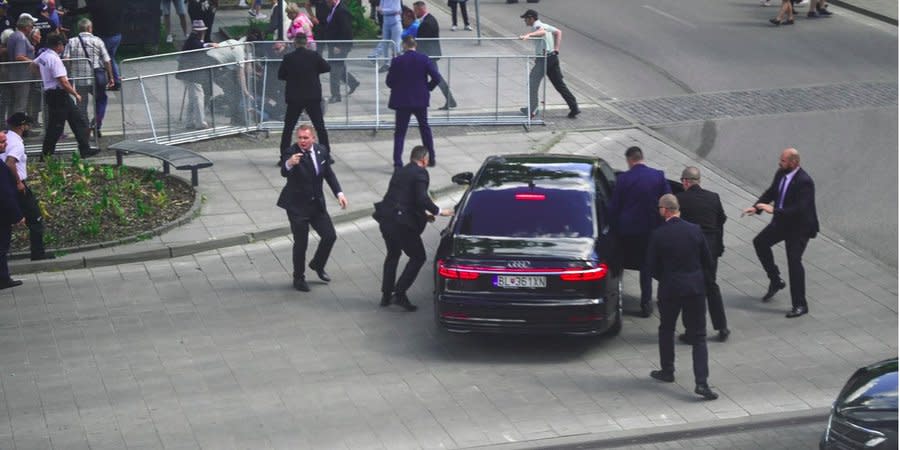 Security service personnel are preparing to transport Robert Fico by car from the scene of the attack on May 15