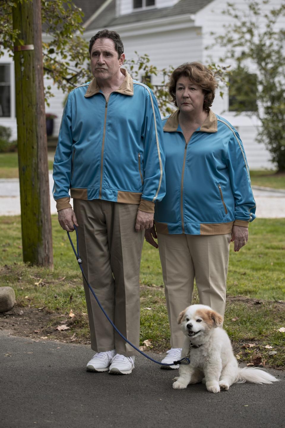 Kind and Martindale in matching jogging suits and walking their dog in "The Watcher"