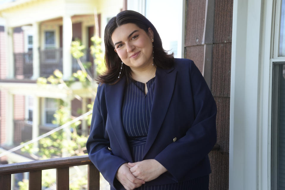 Daniella López White, of Hawaii, poses for a photo on Tuesday, May 14, 2024, on the porch of her apartment, in Boston. López White, who graduated from Emerson College in Boston this month and is on a tight budget, said TikTok influencers have helped her with tips on how to find affordable clothes at places like H&M and thrift shops. (AP Photo/Steven Senne)