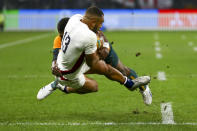 England's Joe Marchant is tackled by Australia's Marika Koroibete during the rugby international between England and the Wallabies in Perth, Australia, Saturday, July 2, 2022. (AP Photo/Gary Day)