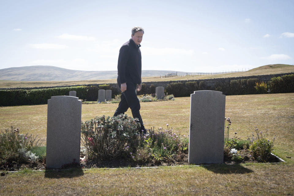 Foreign Secretary Lord David Cameron visits San Carlos Cemetery on the Falkland Islands, during his high-profile visit to demonstrate they are a "valued part of the British family" amid renewed Argentinian calls for talks on their future, in Stanley, Falkland Islands, Britain, on Monday Feb. 19, 2024. (Stefan Rousseau/PA via AP)