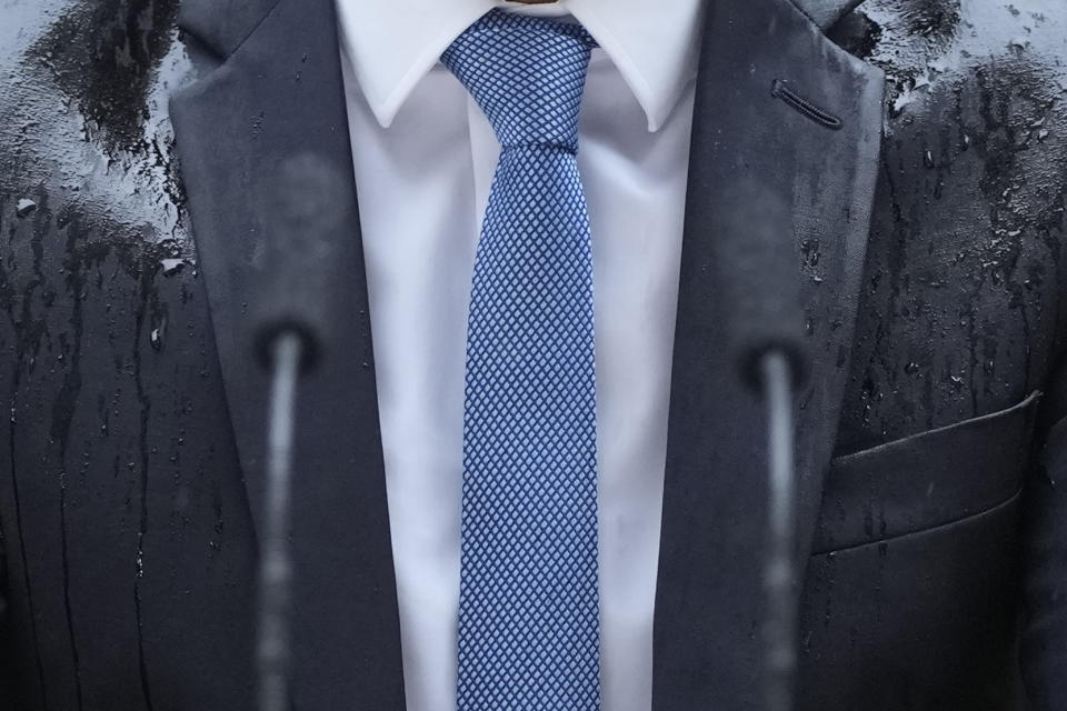 Heavy rain falls on the jacket of Britain's Prime Minister Rishi Sunak as he speaks to the media outside 10 Downing Street in London Wednesday, May 22, 2024, he announced that he has called a General Election for July 4. (AP Photo/Kin Cheung)