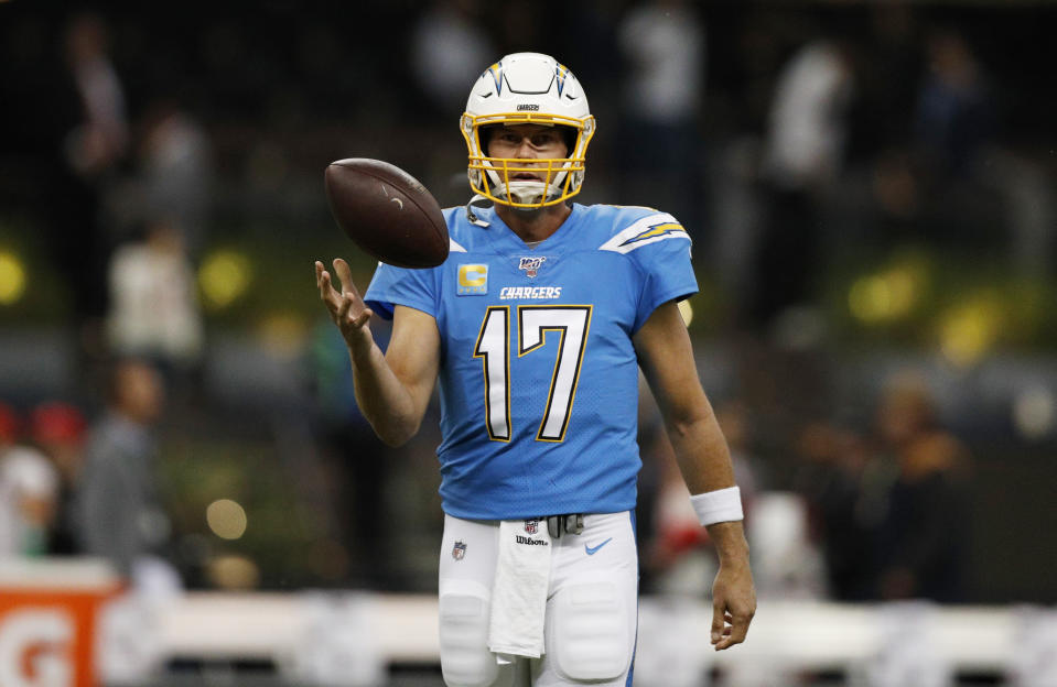 FILE - In this Nov. 18, 2019, file photo, Los Angeles Chargers quarterback Philip Rivers warms up before an NFL football game against the Kansas City Chiefs in Mexico City. Rivers is coming off one of the poorest seasons in his NFL career. The longtime quarterback for the San Diego and Los Angeles Chargers is now with the Colts after signing a one-year, $25 million contract. (AP Photo/Rebecca Blackwell, File)