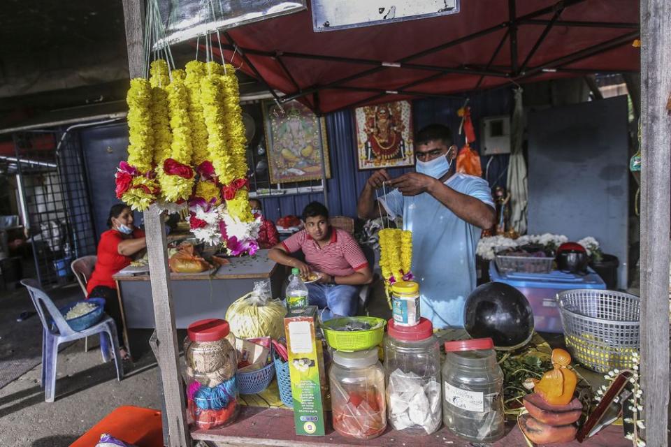 Shanmugam prepares a flower garland near Batu Caves during Thaipusam January 28, 2021. — Picture by Hari Anggara