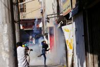 Demonstrators react during the ongoing anti-government protests in Baghdad