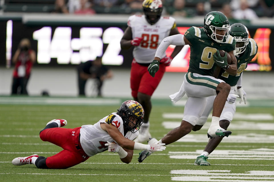 Charlotte wide receiver Elijah Spencer runs past Maryland linebacker Caleb Wheatland during the first half of an NCAA college football game on Saturday, Sept. 10, 2022, in Charlotte, N.C. (AP Photo/Chris Carlson)