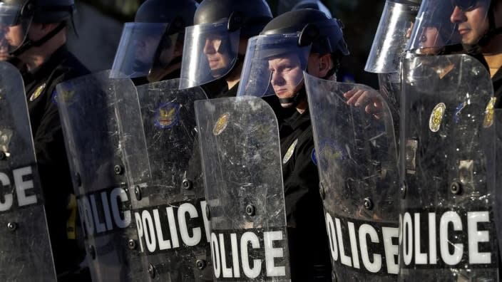 Phoenix Police officers watch protesters rally on June 2, 2020 during demonstrations over the death of George Floyd. Arizona Gov. Doug Ducey has signed into law a measure that makes it illegal to knowingly record video of police officers within 8 feet. (Photo: Matt York/AP, File)