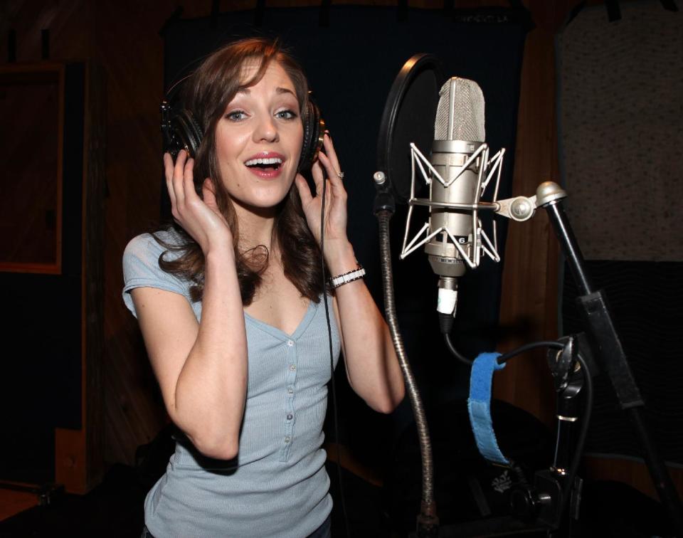 This March 18, 2013 photo released by Fortune Creative shows actress-singer Laura Osnes recording the Original Broadway Cast Recording of Broadway's "Rodgers & Hammerstein's Cinderella” at MSR Studios in New York. The 29-member cast, plus a 20-piece orchestra that was split up over half a dozen rooms and booths, recorded their cast album in one day. (AP Photo/Fortune Creative, Walter McBride)