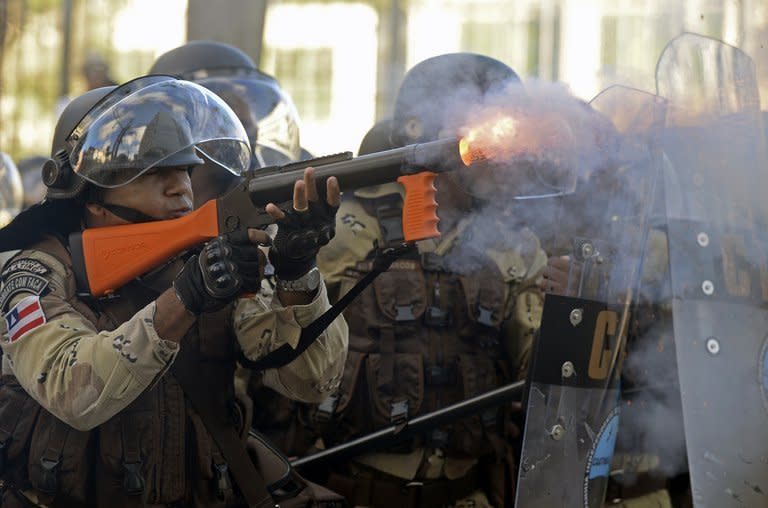 Riot police fire tear gas at protesters blocking access to the Arena Fonte Nova Stadium in Salvador, Bahia on June 20, 2013. Hundreds of thousands of people rallied across Brazil, as a protest movement over the quality of public services and the high cost of staging the World Cup gathered steam