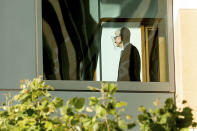 Apple CEO Tim Cook walks through the Ronald V. Dellums building, Friday, May 21, 2021, in Oakland, Calif. Cook is expected to take the witness stand Friday to defend the company's iPhone app store against charges that it has grown into an illegal monopoly — one far more profitable than his predecessor Steve Jobs envisioned when it opened up 13 years ago. (AP Photo/Noah Berger)