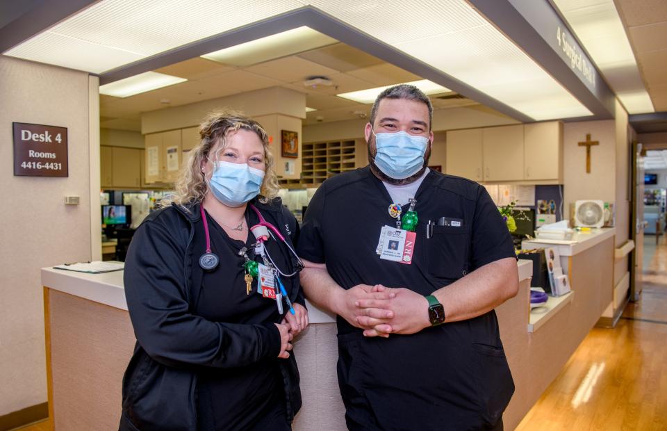 OSF St. Francis Medical Center registered nurses Erika Hulvey, left, of Canton, and Joe Jordan, a traveling nurse from Rock Island pose at a fourth-floor post-op station at the hospital in downtown Peoria. Both OSF HealthCare and UnityPoint Health have seen compensation rates skyrocket for traveling nurses while new staff openings remain unfilled, prompting both hospitals to offer hiring bonuses and retention incentives.