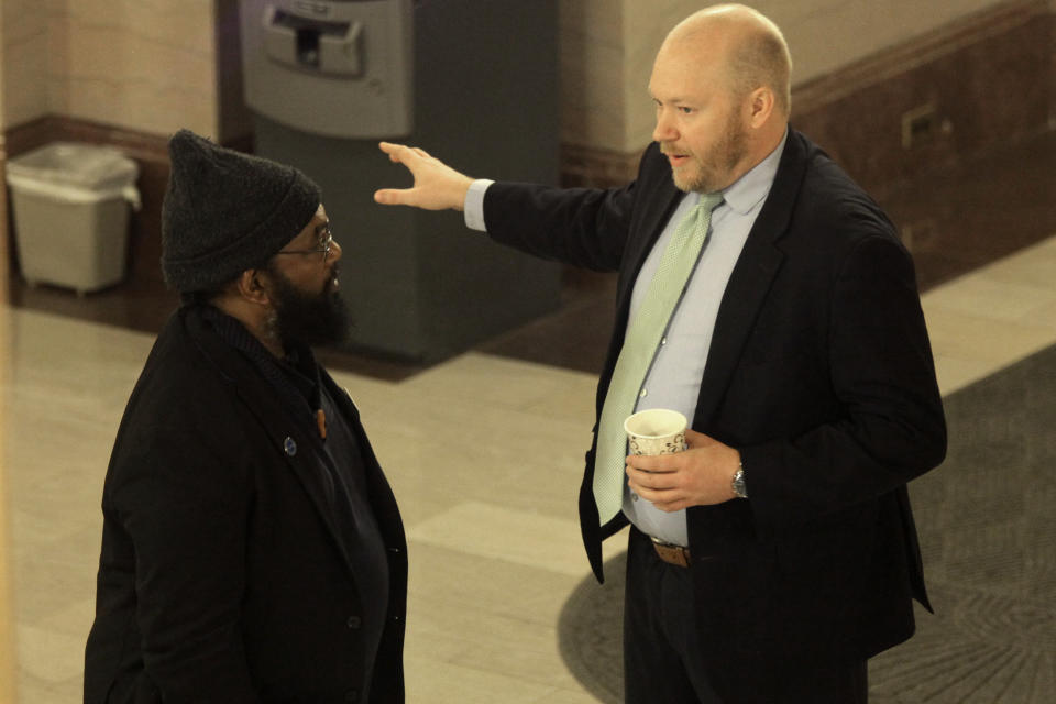 Kansas state Rep. Marvin Robinson, left, D-Kansas City, confers with Will Lawrence, right, Democratic Gov. Laura Kelly's chief of staff, outside a meeting of Democrats ahead of a successful vote in the House to override Kelly's veto of a bill banning transgender athletes from girl's and women's sports, Wednesday, April 5, 2023, at the Statehouse in Topeka, Kansas. Robinson was the only House Democrat to vote to override Kelly's veto, and that made the difference. (AP Photo/John Hanna)