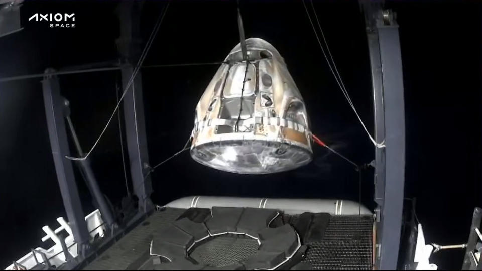 SpaceX Dragon capsule Freedom being hoisted aboard a recovery ship after Ax-2 astronaut splashdown