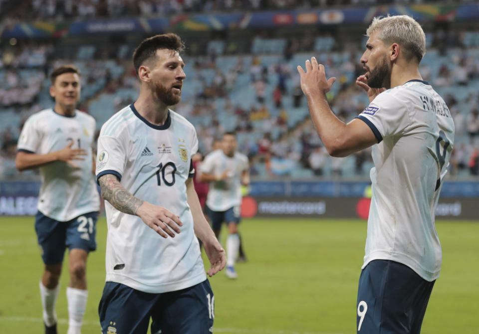 Argentina's Sergio Aguero, right, celebrates with his teammate Lionel Messi after scoring their side's second goal against Qatar during a Copa America Group B soccer match at Arena do Gremio in Porto Alegre, Brazil, Sunday, June 23, 2019. (AP Photo/Silvia Izquierdo)