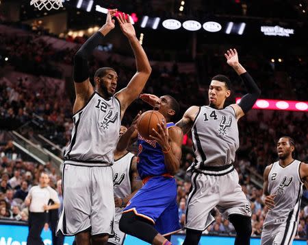 Jan 8, 2016; San Antonio, TX, USA; New York Knicks shooting guard Langston Galloway (2) drives to the basket as San Antonio Spurs power forward LaMarcus Aldridge (12) and shooting guard Danny Green (14) defend during the second half at AT&T Center. Mandatory Credit: Soobum Im-USA TODAY Sports