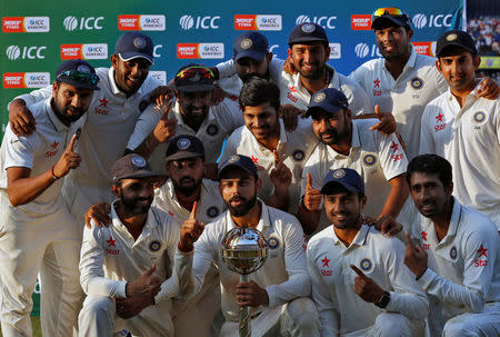 Cricket - India v New Zealand - Third Test cricket match - Holkar Cricket Stadium, Indore - 11/10/2016. India's players pose the ICC best test team trophy after winning the test series. REUTERS/Danish Siddiqui