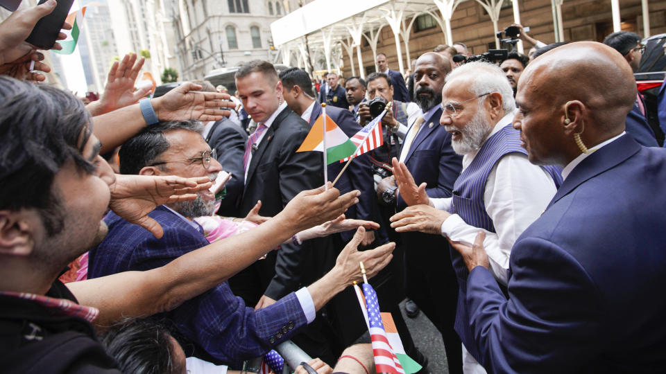 Indian Prime Minister Narendra Modi, 2nd right, greets supporters as he arrives in New York on Tuesday, June 20, 2023. (AP Photo/Eduardo Munoz Alvarez)