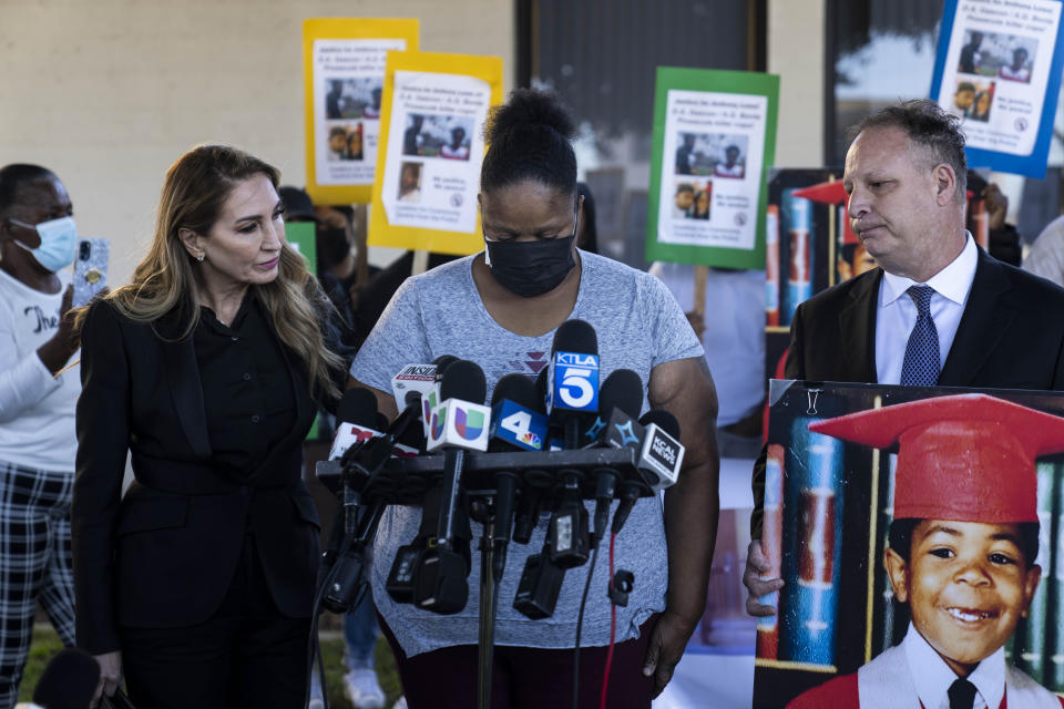 Flanked by her attorneys, Annee Della Donna, left, and Eric Dubin, Dorothy Lowe, the mother of Anthony Lowe, speaks during a news conference in Huntington Park, Calif., Monday, Feb. 6, 2023. Lowe, a double-amputee in a wheelchair, was fatally shot by police in January after a victim reported being stabbed by him. When the officers approached the suspect, he pulled out a foot-long (30 cm) knife and tried to throw it at them, according to a statement by Los Angeles County Sheriff's Department. (AP Photo/Jae C. Hong)