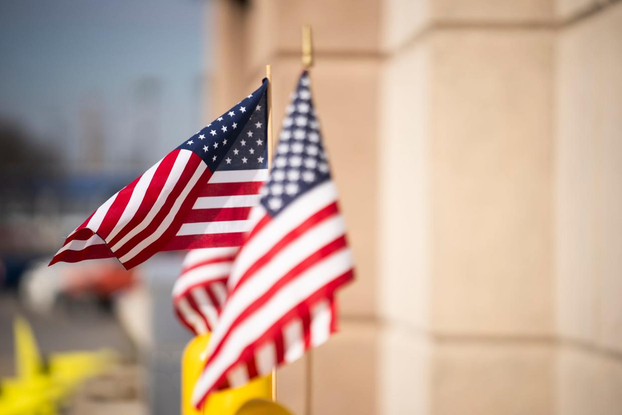 Feb 21, 2024; Columbus, Ohio, USA; American flags are tied to bollards near the entrance to the Early Voting entrance at the Franklin County Board of Elections.