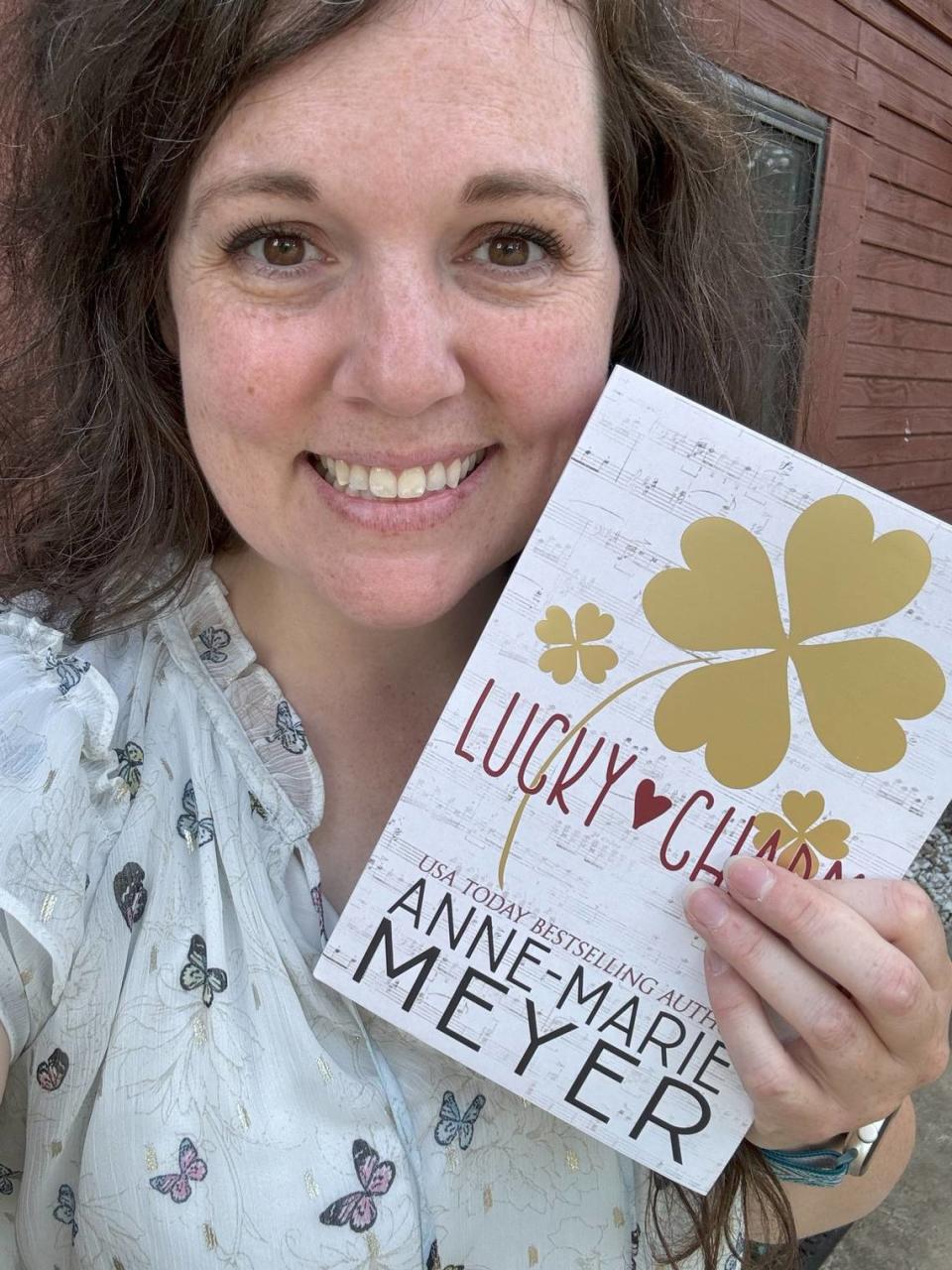 Author Anne-Marie Meyer with her book “Lucky Charm,” which was inspired by Travis Kelce and Taylor Swift.