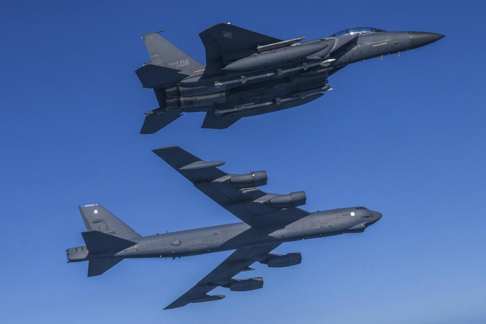In this photo provided by South Korea Defense Ministry, a U.S. Air Force B-52H Stratofortress aircraft, bottom, flies in formation with South Korea's Air Force F-15K fighter over the western sea of Korean peninsula during a joint air drill in South Korea, Monday, March 6, 2023.(South Korea Defense Ministry via AP)