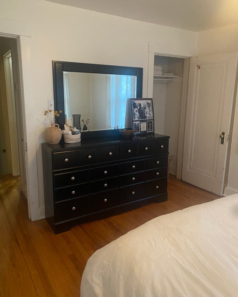 Black dresser in bedroom before being turned into nursery.