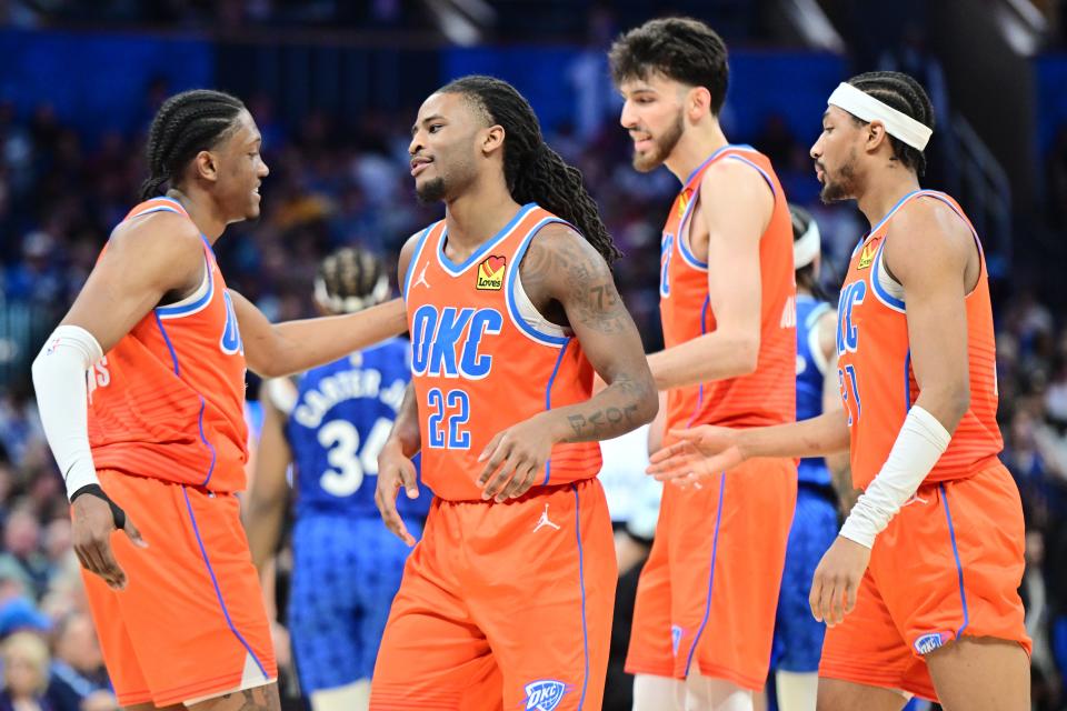 ORLANDO, FLORIDA - FEBRUARY 13: (L-R) Jalen Williams #8, Cason Wallace #22, Chet Holmgren #7 and Aaron Wiggins #21 of the Oklahoma City Thunder celebrate in the second half against the Orlando Magic at Kia Center on February 13, 2024 in Orlando, Florida. NOTE TO USER: User expressly acknowledges and agrees that, by downloading and or using this photograph, User is consenting to the terms and conditions of the Getty Images License Agreement. (Photo by Julio Aguilar/Getty Images)