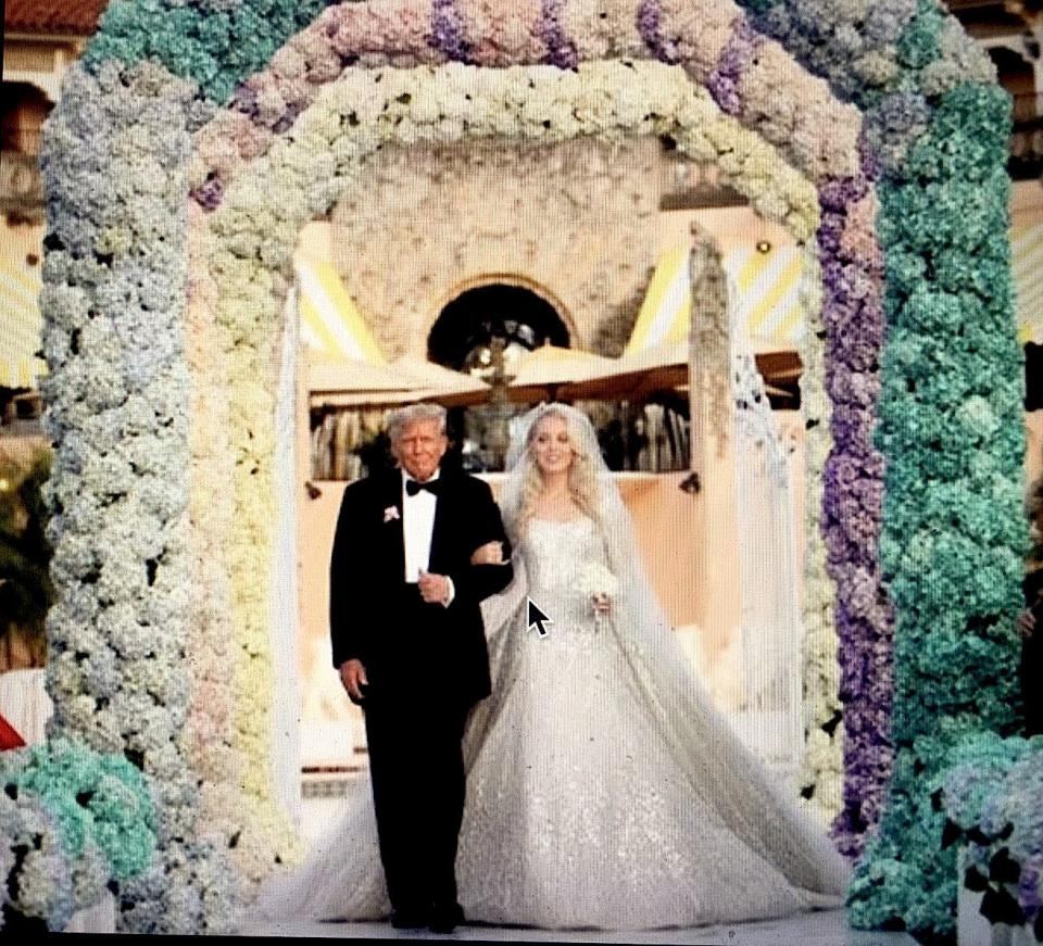 The father of the bride walks his daughter down the aisle