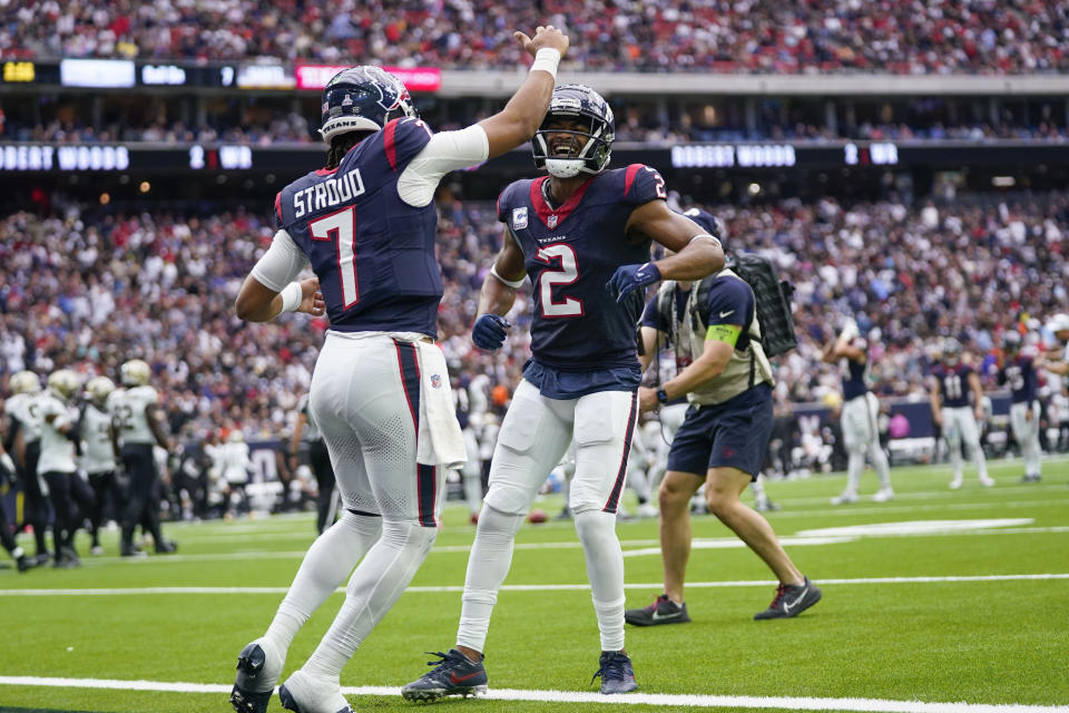 Houston Texans wide receiver Robert Woods (2) celebrates his touchdown reception with quarterback C.J. Stroud (7) in the first half of an NFL football game against the New Orleans Saints in Houston, Sunday, Oct. 15, 2023. (AP Photo/Eric Christian Smith)