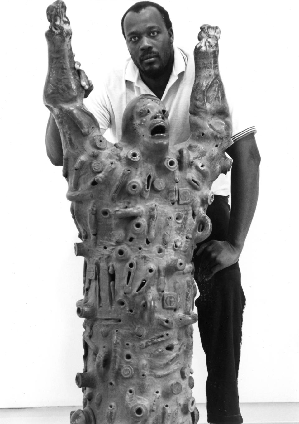 Artist Nathaniel Bustion Jr. is pictured with one of his works, "The Screaming Man," which he said captured the anger, pain and frustration of the Black experience.