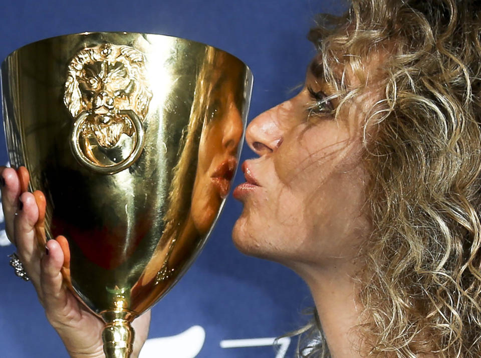 File - Actress Valeria Golino poses with her Coppa Volpi for best actress for her role in the movie 'For your love'. The 77th Venice Film Festival will kick off on Wednesday, Sept. 2, 2020, but this year's edition will be unlike any others. Coronavirus restrictions will mean fewer Hollywood stars, no crowds interacting with actors and other virus safeguards will be deployed. (Photo by Joel Ryan/Invision/AP, File)