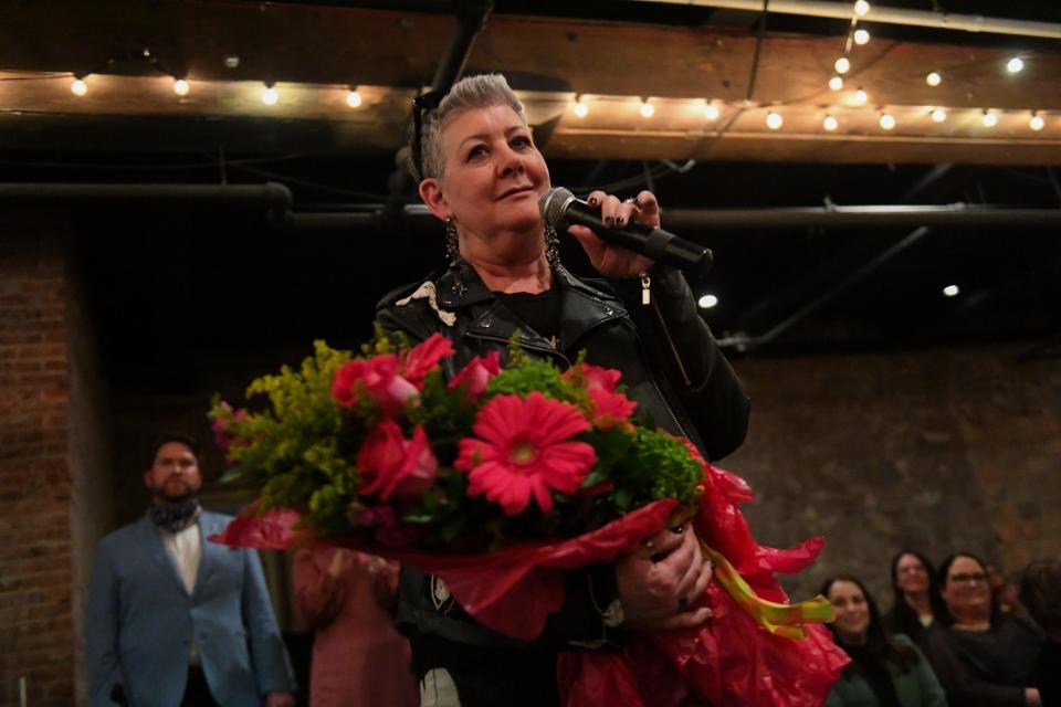 Fashion designer Shannon Wright receives flowers as a goodbye gift during the "Transform the Runway" fashion show on Thursday, Nov. 9, 2023 at Icon Lounge in Sioux Falls, South Dakota.