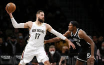 New Orleans Pelicans center Jonas Valanciunas (17) drives to the basket against Brooklyn Nets center Day'Ron Sharpe (20) during the first half of an NBA basketball game, Saturday, Jan. 15, 2022, in New York. (AP Photo/Noah K. Murray)