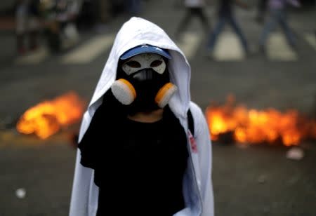 A demonstrator looks on while rallying against Venezuela's President Nicolas Maduro's government in Caracas, Venezuela, August 4, 2017. REUTERS/Ueslei Marcelino