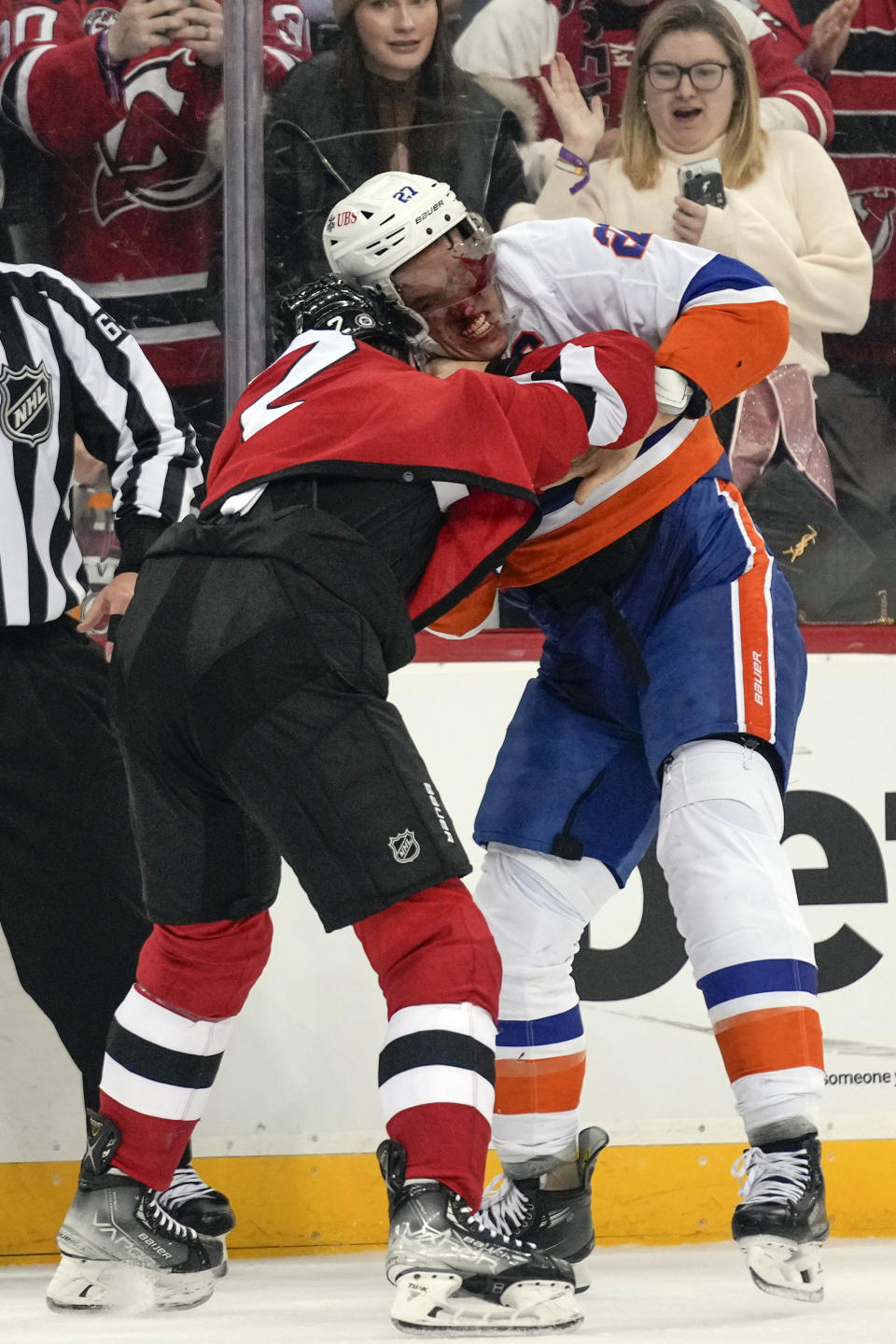 New Jersey Devils' Brendan Smith, left, fights with New York Islanders' Anders Lee during the third period of an NHL hockey game in Newark, N.J., Tuesday, Nov. 28, 2023. The Devils defeated the Islanders 5-4. (AP Photo/Seth Wenig)
