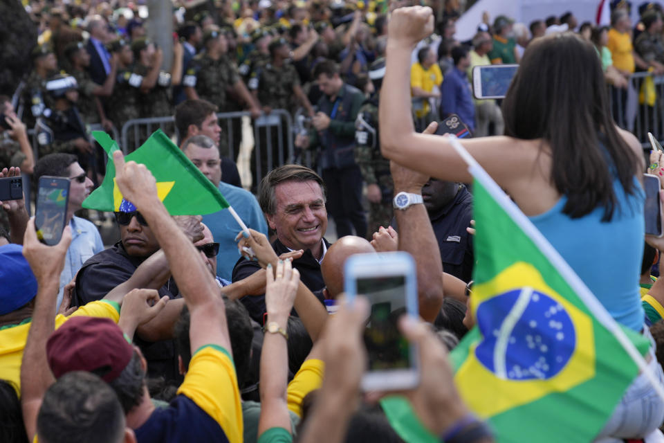 Brazil's President Jair Bolsonaro greets supporters upon his arrival at a military display and rally to celebrate the bicentennial of the country's independence from Portugal, in Rio de Janeiro, Brazil, Wednesday, Sept. 7, 2022. (AP Photo/Silvia Izquierdo)