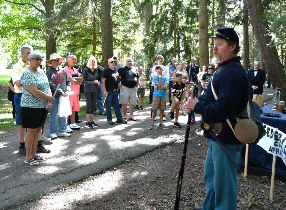Civil War re-enactor Mike Fahle stands at one of the stops on the reverse parade held at the Rutherford B. Hayes Library and Museums.