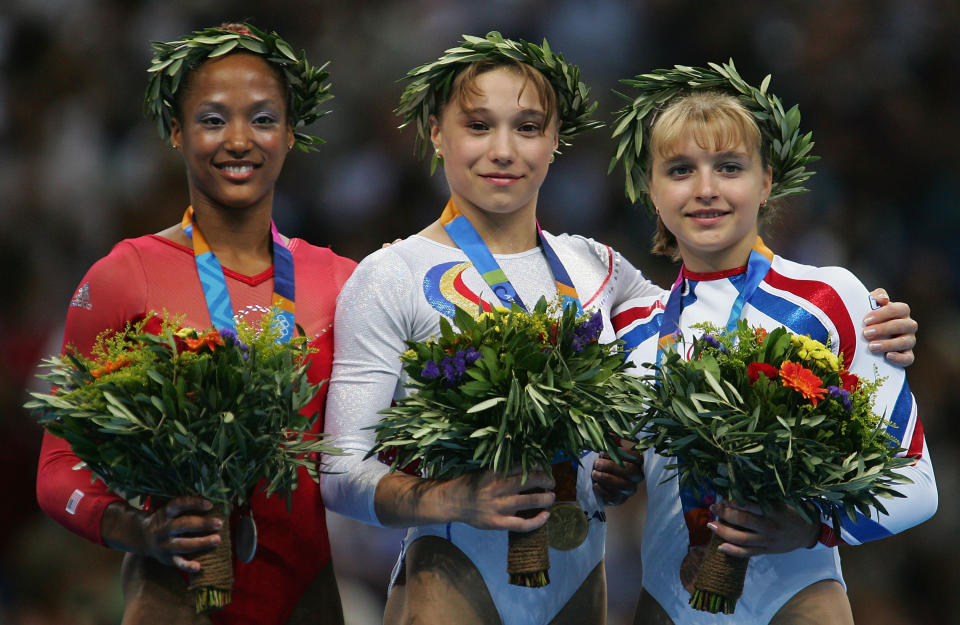 ATHENS - AUGUST 22:  Annia Hatch of the USA (silver), Monica Rosu of Romania (gold) and Elena Zamolodchikova of Russia (Bronze) stand on the dias after the medal ceremony for the women's artistic gymnastics vault event on August 22, 2004 during the Athens 2004 Summer Olympic Games at the Olympic Sports Complex Indoor Hall in Athens, Greece. (Photo by Chris McGrath/Getty Images)