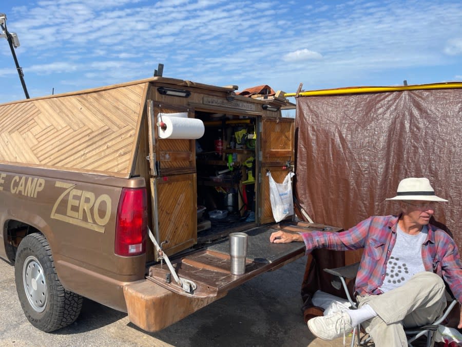 Calvin Wehrle, of Galveston, Texas, passes out gifts to children at the SpaceX South Texas launch facility in Boca Chica Beach on Nov. 1, 2023. (Sandra Sanchez/Border Report)