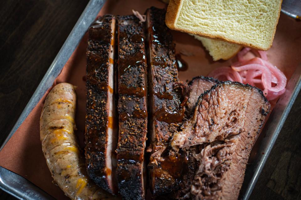The Texas Trinity, at Holy Que Smokehouse in Lahaska, comes with a third pound of sliced brisket, brats and pork spare ribs.