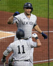 New York Yankees' Giancarlo Stanton, top, celebrates with Anthony Volpe as he returns to the dugout after hitting a solo home run off Pittsburgh Pirates starting pitcher Luis Ortiz during the third inning of a baseball game in Pittsburgh, Saturday, Sept. 16, 2023. (AP Photo/Gene J. Puskar)