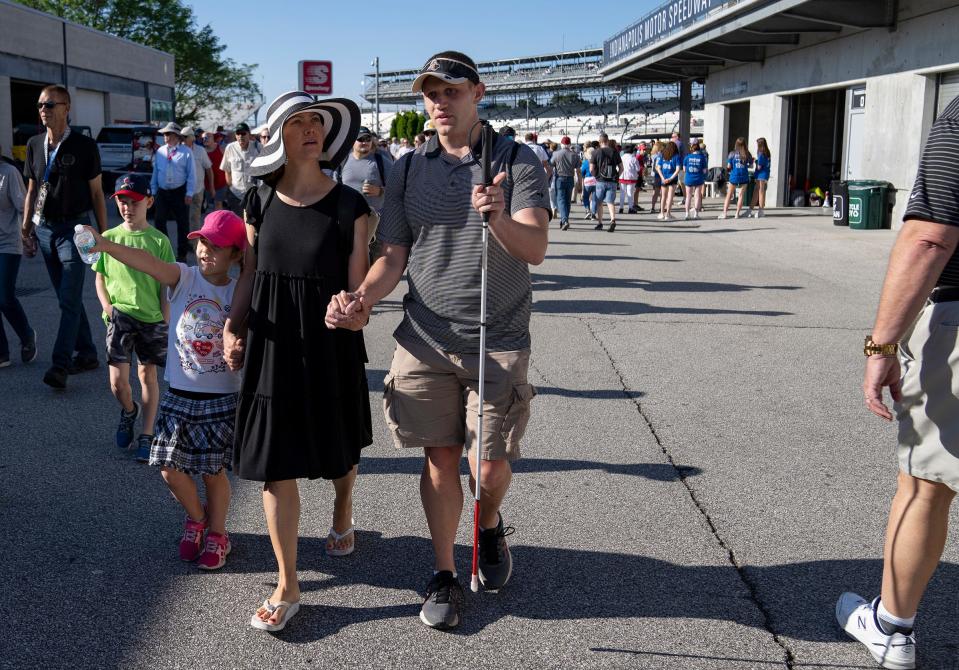 Brian and Laura Petraits and their children Noel, 5, and Neil, 7, walk around near the pits before the 106th running of the Indianapolis 500 on Sunday, May 29, 2022, at Indianapolis Motor Speedway.