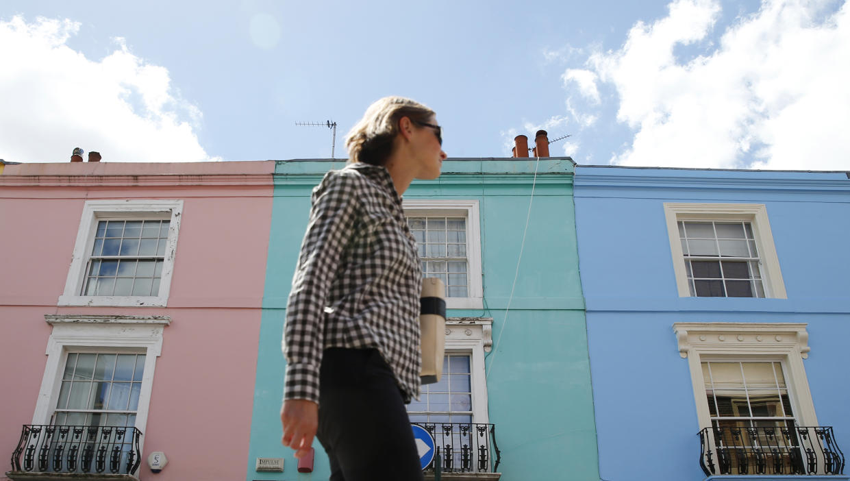 house price A woman walks past a row of houses in London, Britain June 3, 2015. British house prices rose at their slowest annual rate in nearly two years in May, as growth continued to moderate after double-digit increases in the middle of 2014, figures from mortgage lender Nationwide showed on Wednesday. REUTERS/Suzanne Plunkett