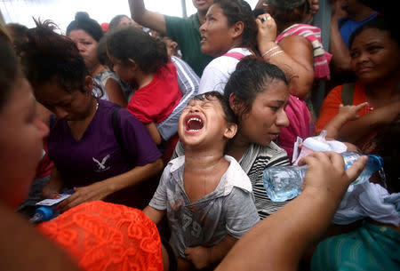 A Central American migrant, part of a caravan trying to reach the U.S., reacts as he waits to apply for asylum in Mexico at a checkpoint in Ciudad Hidalgo, Mexico, October 20, 2018. REUTERS/Edgard Garrido/File photo