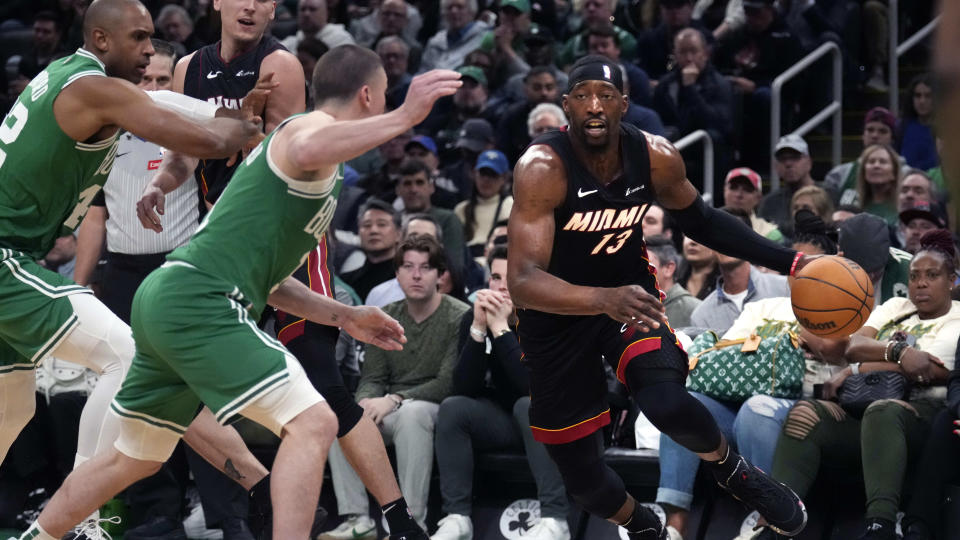 Miami Heat center Bam Adebayo, right, drives to the basket against the Boston Celtics during the second half of Game 2 of an NBA basketball first-round playoff series, Wednesday, April 24, 2024, in Boston. (AP Photo/Charles Krupa)